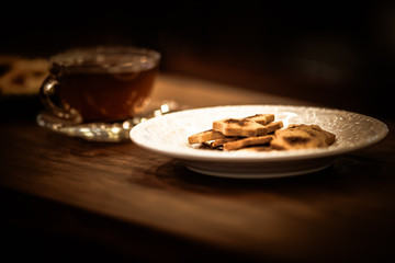 Tea cups with thin cream wafers. Teas with hot smoke. Fine cookies with accompanying special teas.