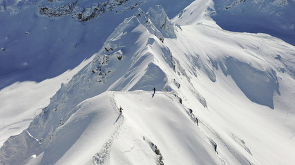 4k aerial photo with ski mountaineers competing during a ski touring race