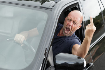 impudent man at the wheel shows an indecent gesture