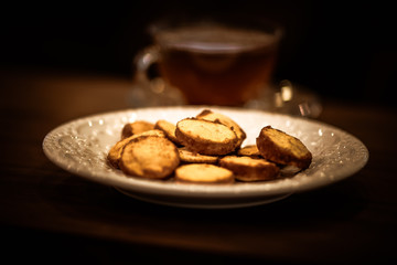 Tea cups with thin cream wafers. Teas with hot smoke. Fine cookies with accompanying special teas.