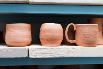 Many different ceramic items on store shelves