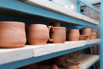 Many different ceramic items on store shelves