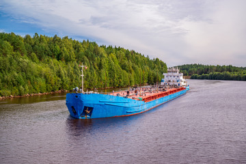 Barges with cargo swimming along the banks of the north-west river