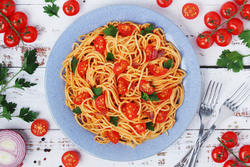 A plate with spaghetti with tomatoes