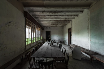Interior of a dining room without people with a large wooden table
