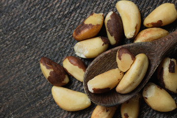Brazilian nuts in a bowl on a wooden table. Kitchen background.