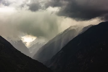 Papier Peint photo autocollant Annapurna Cloud and rains over the steep ridges of the Annapurna mountains in the Nepal Himalaya.
