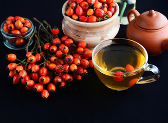 herbal tea with rose canina hips isolated on black, Medicinal plants and herbs composition