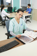 medical secretary going through appointments book