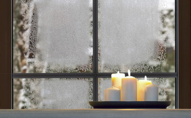 Beautiful burning candles and fairy lights on windowsill indoors
