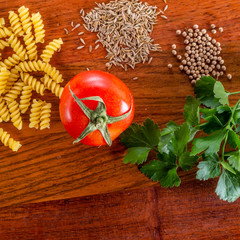 Spaghetti and tomatoes with spices and herbs on an old countertop - 309851273