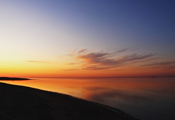 Fototapeta na wymiar colorful sunset over the sea dark horizon