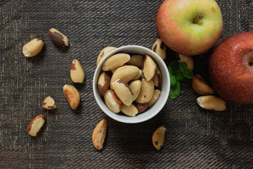Brazilian nuts in a bowl on a wooden table. Kitchen background.