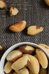 Brazilian nuts in a bowl on a wooden table. Kitchen background.