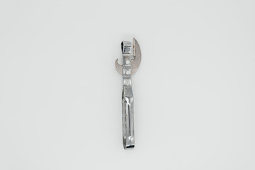 Old can opener on a white background close-up