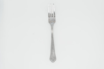 Fork on white background close-up