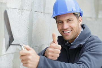 construction worker holding thumbs up