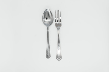 Fork and spoon on white background close-up