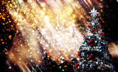 Fototapeta na wymiar Christmas tree against a glittery luminous background