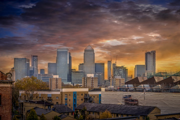 View of the London bank district on Canary Wharf with docks and dramatic sunset sky