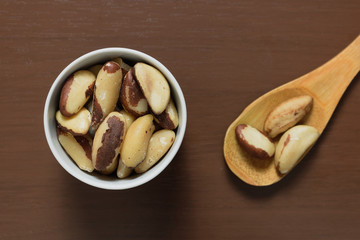 Brazilian nuts in a bowl on a wooden table. Kitchen background.