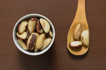 Brazilian nuts in a bowl on a wooden table. Kitchen background.