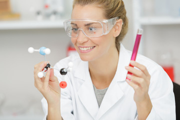 happy scientist holding samples with positive testing solution