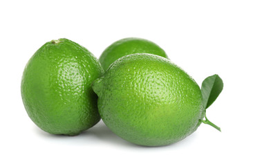 Fresh ripe limes with green leaf isolated on white