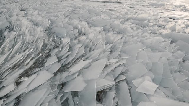 Aerial view of a frozen river. Fancy ice texture, cold chained water. Shards of ice stick out with sharp edges.