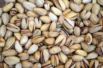 Roasted and salted pistachios as background