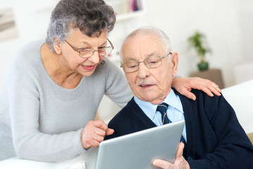 elderly couple in front of the tablet