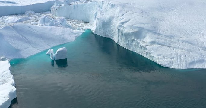 4k Video of Icebergs and ice from melting glacier in icefjord in Ilulissat, Greenland. Global Warming and Climate Change. Aerial video of arctic nature ice landscape. Unesco World Heritage Site.