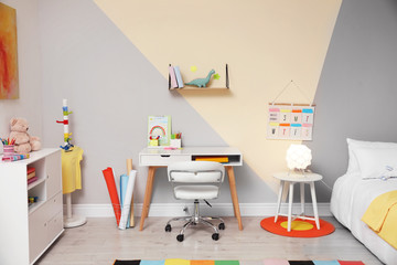 Stylish child room interior with comfortable bed and desk