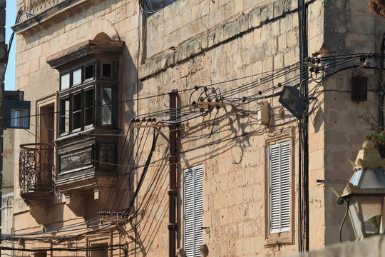 Messy electrical cables on buildings in Malta