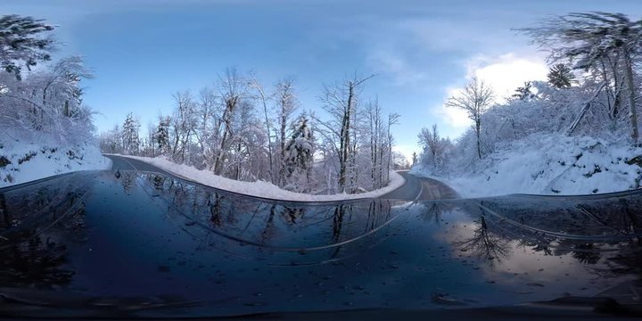 VR360 Car driving on a snowy road on a sunny winter day