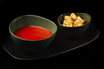 Gazpacho cold summer vegetarian tomato soup with creamy on a black background. Summer soup concept