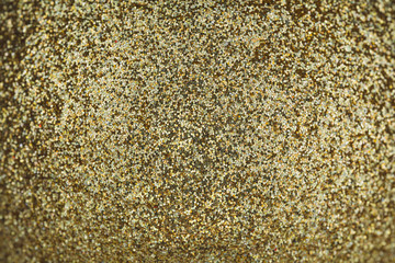 Macro photo of a golden christmas ball, bauble surface. Glittery gold texture. Close up photo.