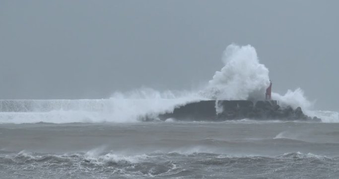 Hurricane Waves Crash Over Sea Wall And Lighthouse - Halong