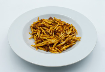  Trofie, traditional italian pasta, with beef in ragu bolognese. White dish, white background. Traditional pasta.