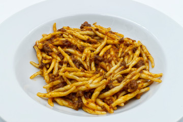  Trofie, traditional italian pasta, with beef in ragu bolognese. White dish, white background. Traditional pasta.