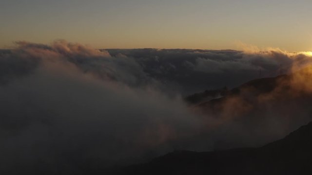 Flying above clouds at sunset. Beautiful aerial Cloudscape. 