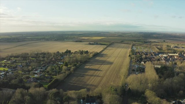 Aerial footage of Hornsea town and Hornsea Freeport clothes outlet from above during morning sunrise in Winter