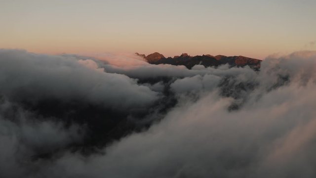 4K drone shot of dreamy misty mountains. Cinematic sunset scene. 