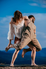 Beautiful couple modern jazz contemporary style dancers on a mountain