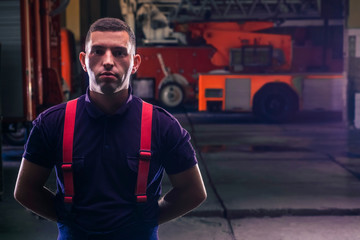 Portrait of a firefighter with uniform inside the fire station