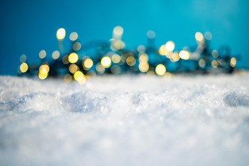bokeh Christmas lights in snow - holiday background