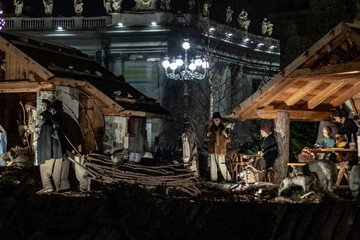 Fototapeta na wymiar Rome Italy; 8 December 2019. In Piazza San Pietro the nativity scene reproduced with the wood of Trentino. With the Christmas tree in the background.