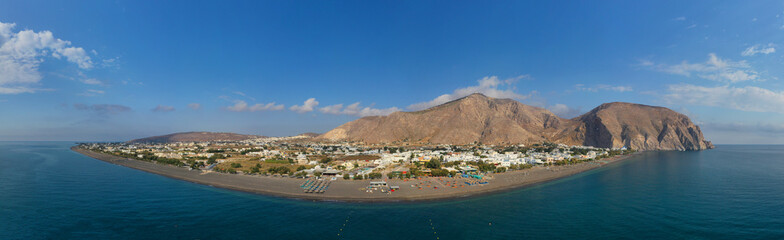 Aerial drone panoramic photo of famous black sand volcanic beach of Perissa in island of Santorini, Cyclades, Greece