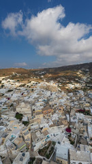 Fototapeta na wymiar Aerial drone panoramic photo of small picturesque village of Emporeio in Santorini volcanic island, Cyclades, Greece