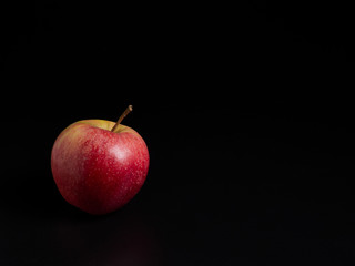 red apple on black background
